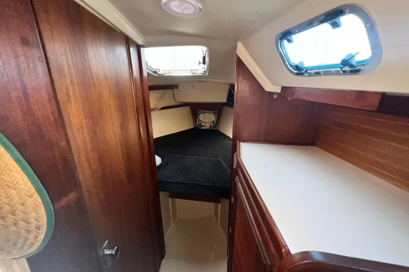 Slide: The Image of 1987 Catalina 30 MkII cabin interior with wood paneling and cozy sleeping area. - 36