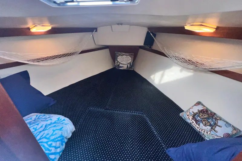 Slide: The Image of Cozy interior cabin of 1987 Catalina 30 MkII sailboat with pillows and netting. - 37