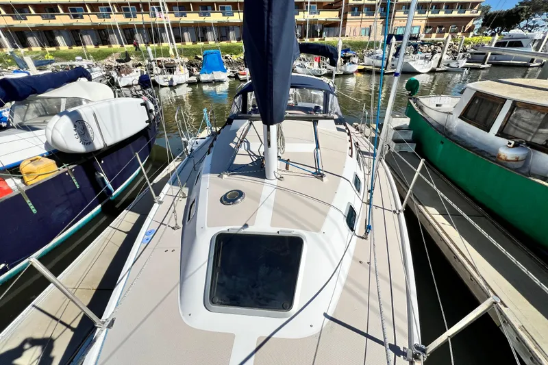Slide: The Image of 1987 Catalina 30 MkII sailboat docked at marina, surrounded by other boats. - 4