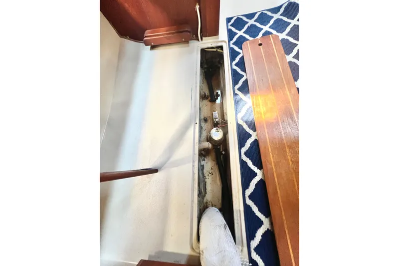 Slide: The Image of Interior view of a 1987 Catalina 30 MkII sailboat, showing a compartment with mechanical components. - 41