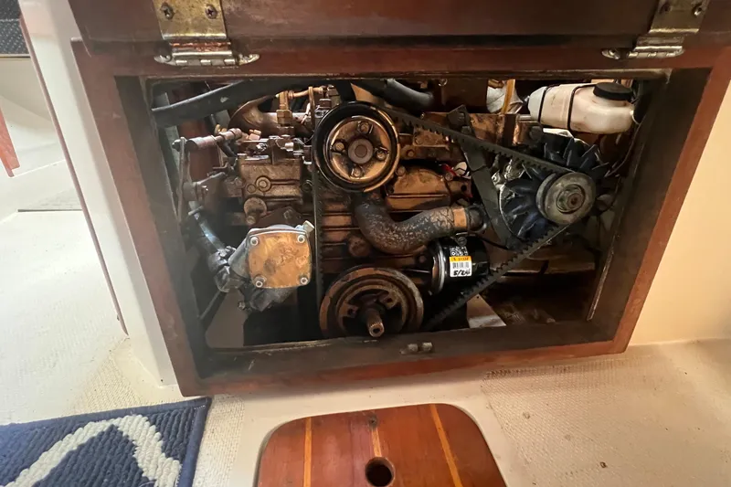 Slide: The Image of Engine compartment of a 1987 Catalina 30 MkII sailboat, showcasing mechanical components. - 43
