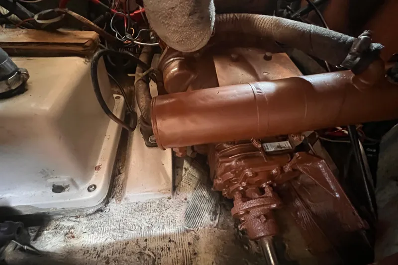 Slide: The Image of Engine compartment of a 1987 Catalina 30 MkII sailboat, showing mechanical components and wiring. - 45