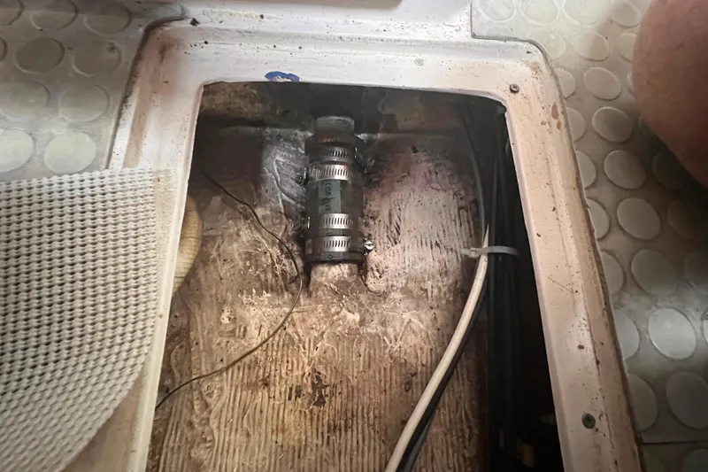 Slide: The Image of Bilge area of a 1987 Catalina 30 MkII sailboat with visible hose clamps and wiring. - 46