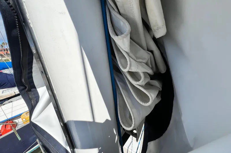 Slide: The Image of Folded sail on a 1987 Catalina 30 MkII sailboat, docked at a marina. - 9