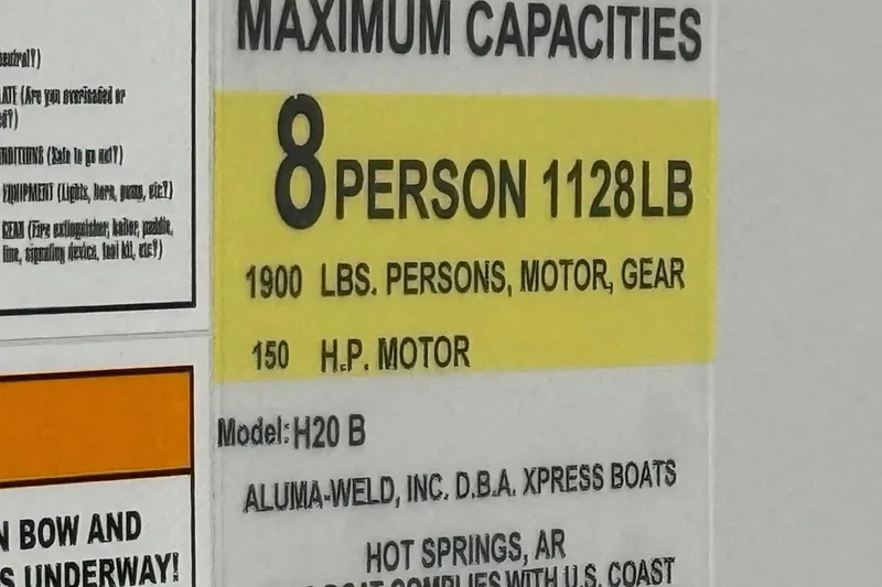 Slide: The Image of 2026 Express H20 Bay boat capacity label: 8 persons, 1128 lbs, 150 HP motor. - 11