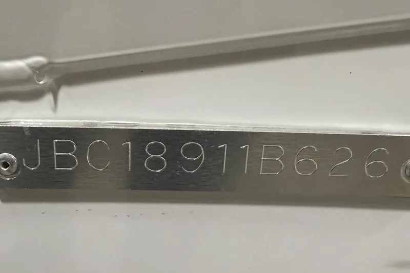Slide: The Image of 2026 Express H20 Bay serial number JBC18911B626 on metal plate. - 12