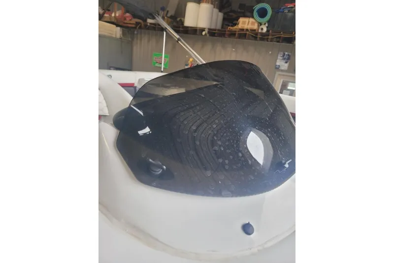 Slide: The Image of 2026 Express H20 Bay boat windshield with water droplets in a garage setting. - 15