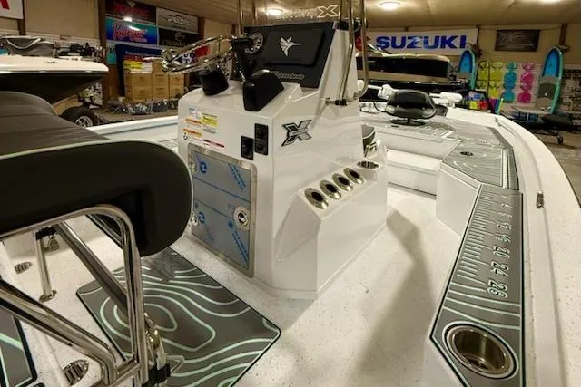 Slide: The Image of 2026 Express H20 Bay boat interior with modern console and seating in showroom. - 3