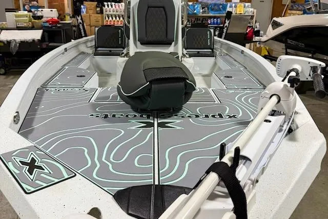 Slide: The Image of 2026 Express H20 Bay boat with custom deck design in a showroom setting. - 4