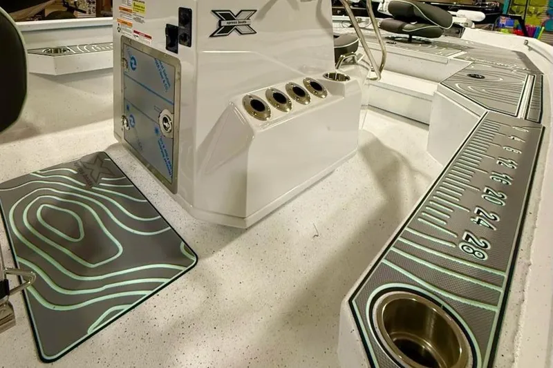 Slide: The Image of 2026 Express H20 Bay boat interior with fishing rod holders and measuring ruler. - 6