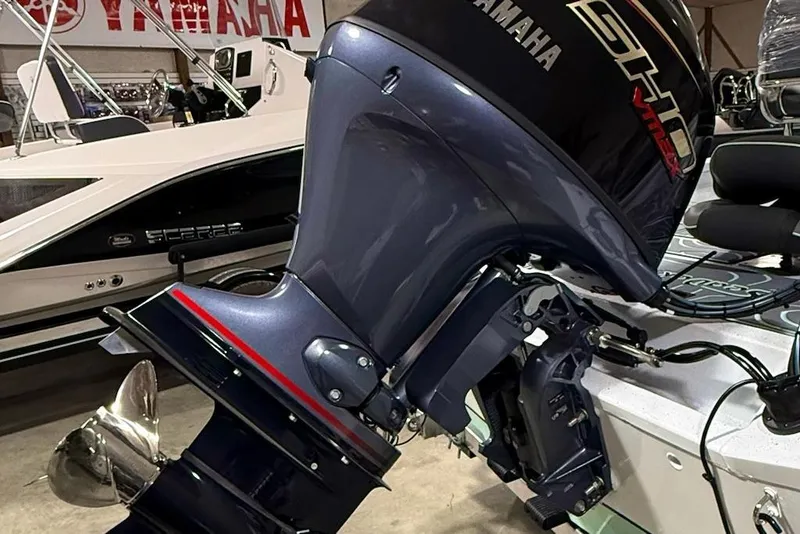 Slide: The Image of 2026 Express H20 Bay boat with Yamaha outboard motor in showroom. - 7