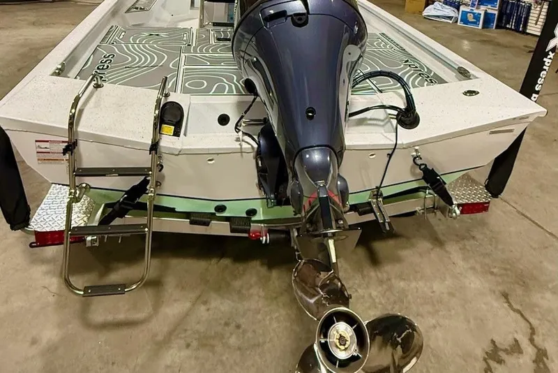 Slide: The Image of 2026 Express H20 Bay boat with outboard motor and ladder in a garage setting. - 8