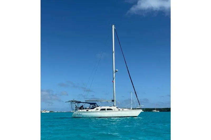 Slide: The Image of Sailboat Catalina Morgan 440, 2007 model, anchored in clear blue waters under a sunny sky. - 2