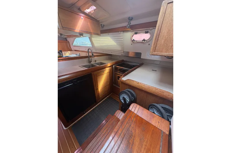 Slide: The Image of Cockpit of 2007 Catalina Morgan 440 sailboat with seating and steering wheel. - 21