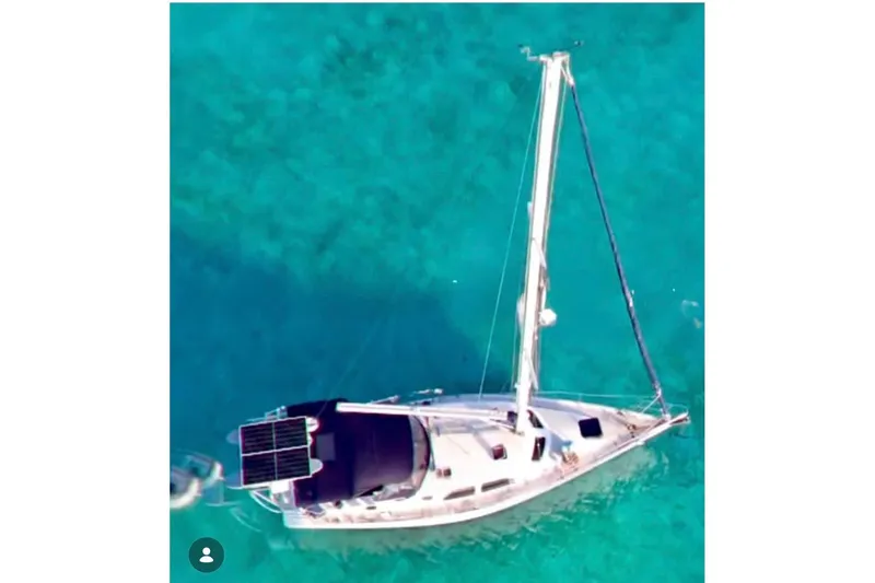 Slide: The Image of Aerial view of 2007 Catalina Morgan 440 sailboat on clear turquoise water. - 4