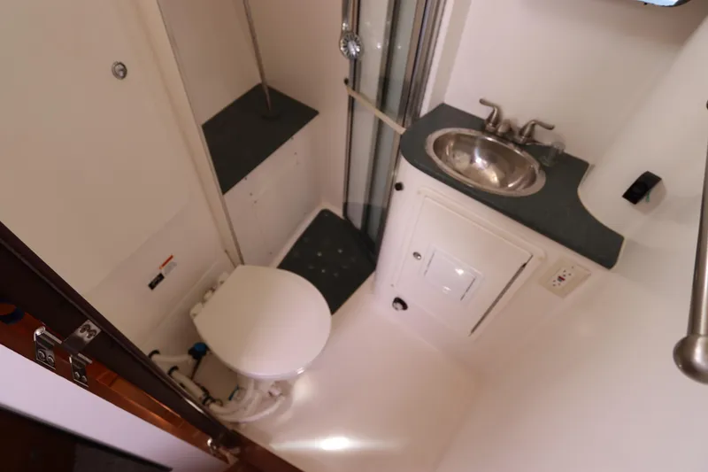 Slide: The Image of Compact bathroom in 2007 Catalina Morgan 440 yacht with toilet, sink, and shower. - 49