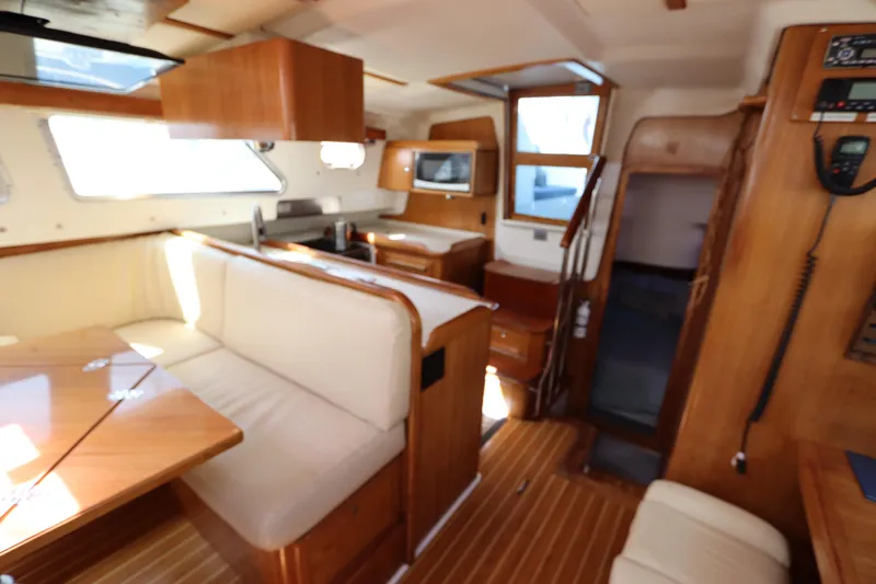 Slide: The Image of Interior of 2007 Catalina Morgan 440 yacht with wooden furnishings and cozy seating area. - 50