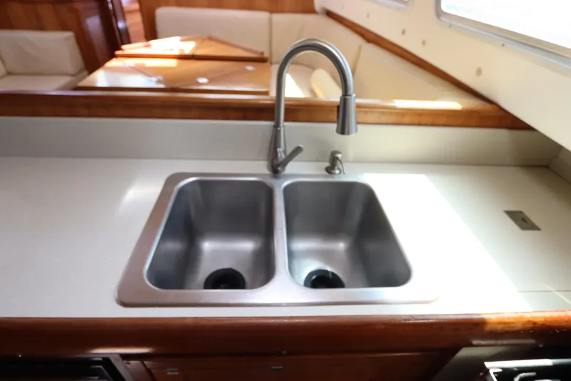 Slide: The Image of Galley sink in 2007 Catalina Morgan 440 yacht, featuring dual basins and modern faucet. - 53