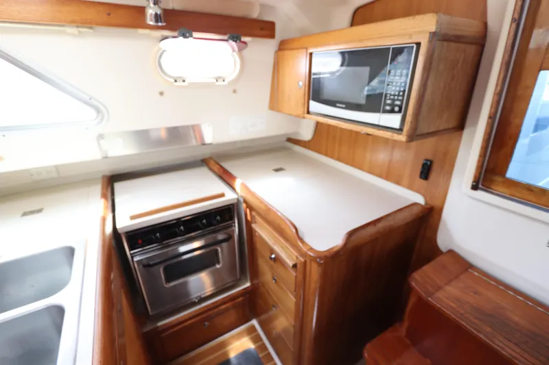 Slide: The Image of Galley kitchen in 2007 Catalina Morgan 440 yacht with microwave and oven. - 54