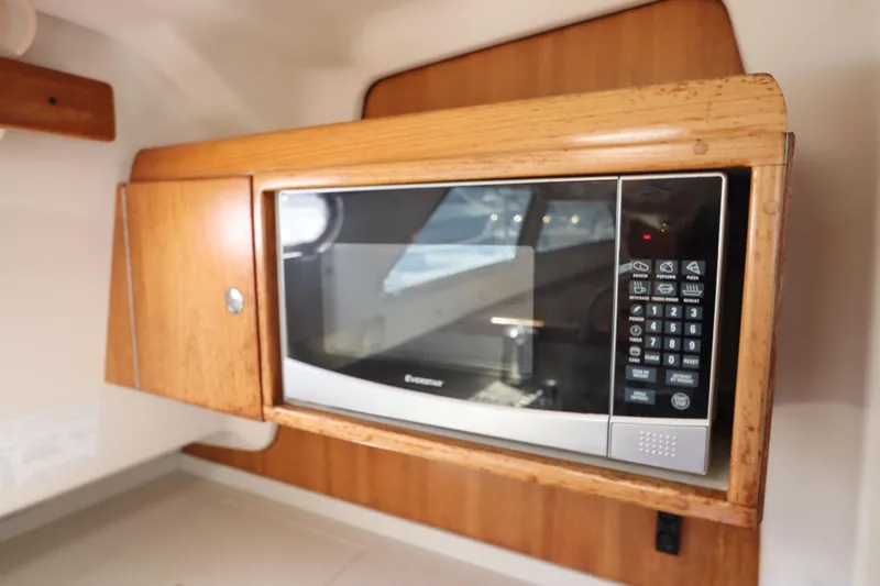 Slide: The Image of Microwave in 2007 Catalina Morgan 440 yacht kitchen with wooden cabinetry. - 58