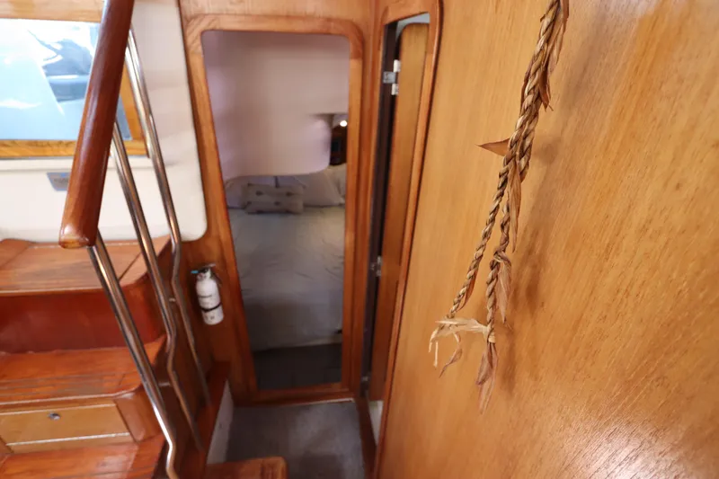 Slide: The Image of Interior of 2007 Catalina Morgan 440 yacht, featuring wooden stairs and cozy cabin entrance. - 63