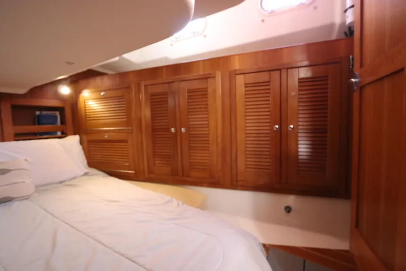 Slide: The Image of Cozy cabin interior of 2007 Catalina Morgan 440 yacht with wooden cabinets and bed. - 65
