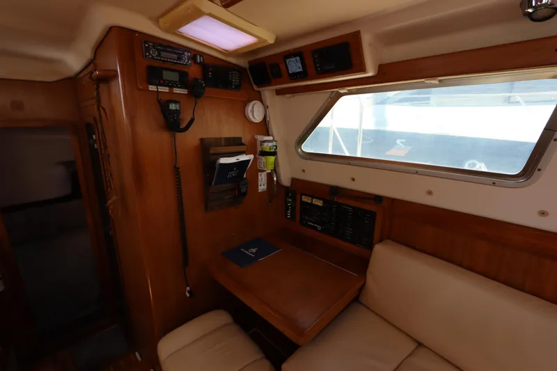 Slide: The Image of Interior of 2007 Catalina Morgan 440 yacht with navigation equipment and seating area. - 67