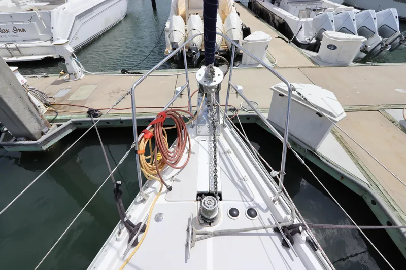 Slide: The Image of 2007 Catalina Morgan 440 sailboat with dinghy and American flag at marina. - 7