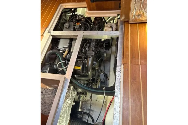 Slide: The Image of Engine compartment of a 2007 Catalina Morgan 440 sailboat, showcasing mechanical components. - 71