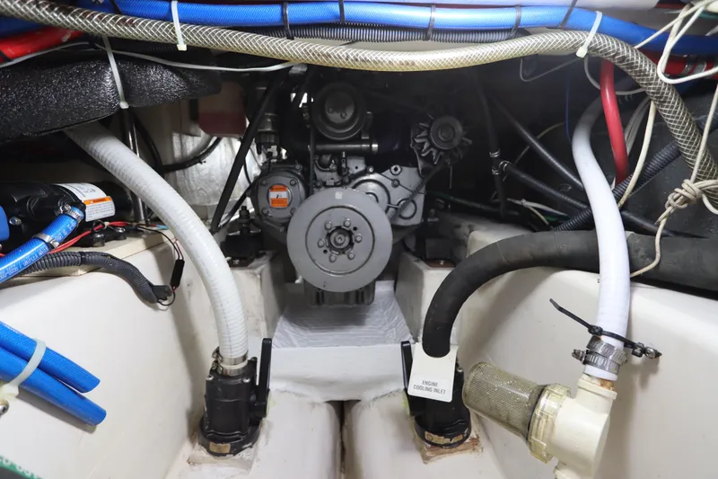Slide: The Image of Engine compartment of a 2007 Catalina Morgan 440 sailboat, featuring hoses and mechanical components. - 73