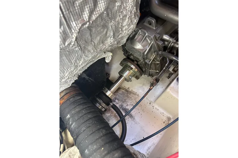 Slide: The Image of Engine compartment of a 2007 Catalina Morgan 440 sailboat, showing mechanical components. - 74