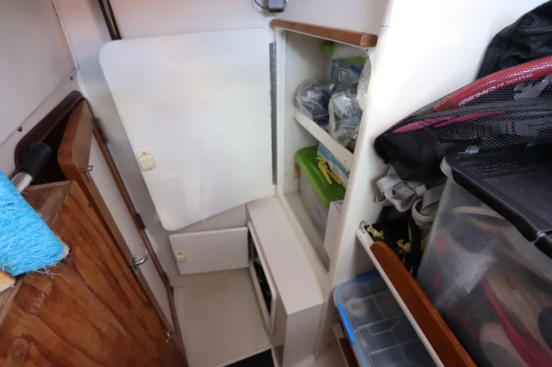 Slide: The Image of Interior storage area of a 2007 Catalina Morgan 440 sailboat with organized shelves. - 84