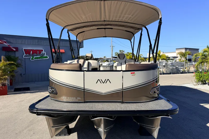 Slide: The Image of 2026 Avalon 2385 LSZ Quad Lounger Tri Toon, high-performance pontoon boat in a marina setting. - 3