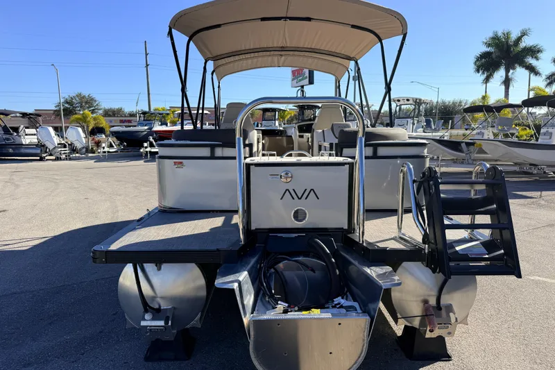 Slide: The Image of 2026 Avalon 2385 LSZ Quad Lounger Tri Toon boat with canopy in a sunny marina. - 6