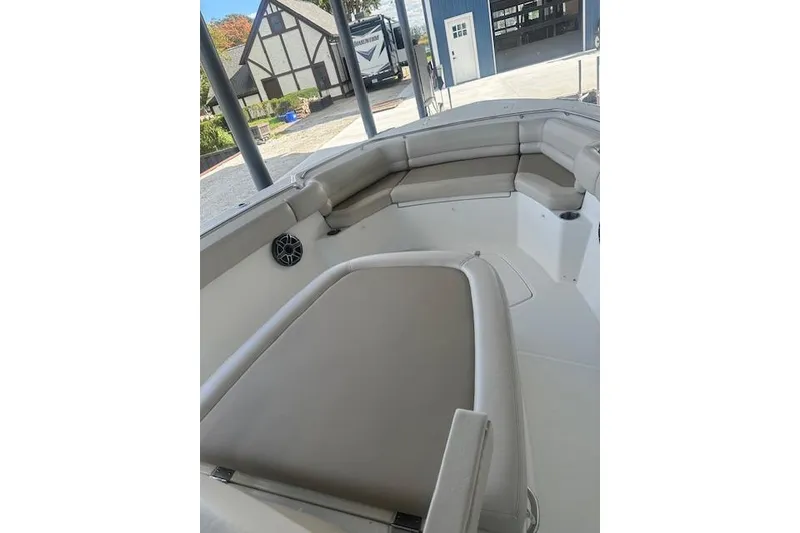 Slide: The Image of 2016 Boston Whaler 330 Outrage boat interior with cushioned seating and modern design. - 6