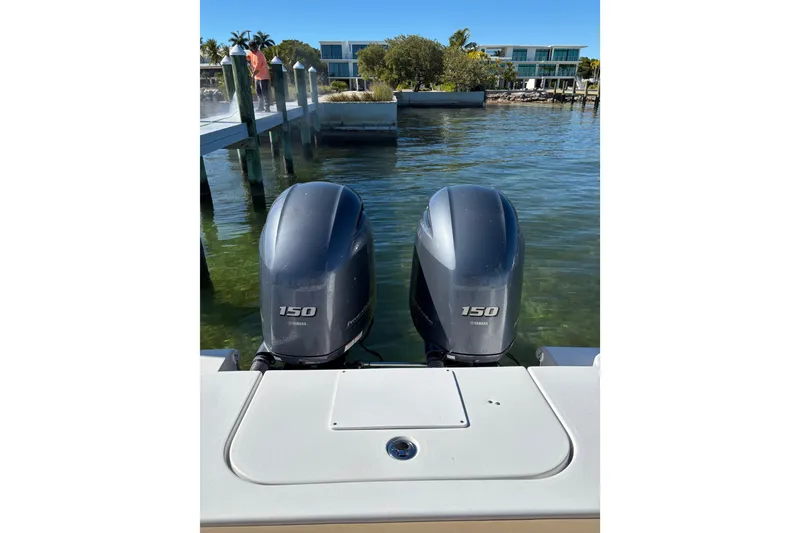 Slide: The Image of 2018 Sea Hunt Gamefish 25 with twin Yamaha 150 outboard motors at a dock. - 15