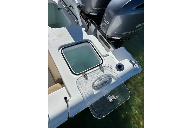 Slide: The Image of 2018 Sea Hunt Gamefish 25 boat with Yamaha engines and open hatch. - 19
