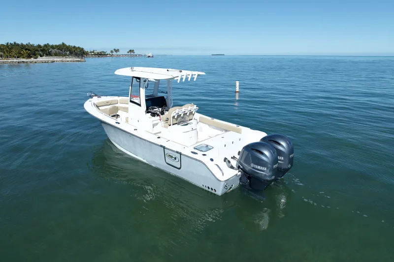 Slide: The Image of 2018 Sea Hunt Gamefish 25 boat with twin Yamaha engines on calm water. - 2