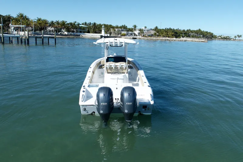 Slide: The Image of 2018 Sea Hunt Gamefish 25 boat with dual engines on calm water. - 3