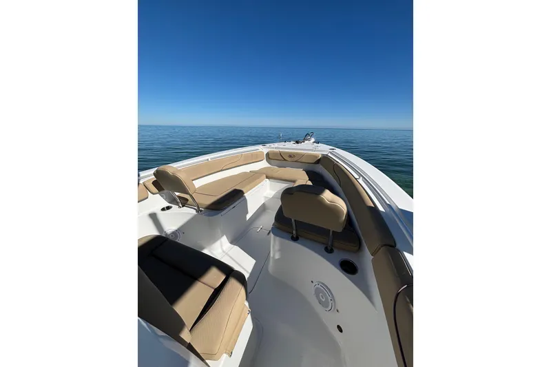 Slide: The Image of 2018 Sea Hunt Gamefish 25 boat interior with tan seating on calm ocean. - 8
