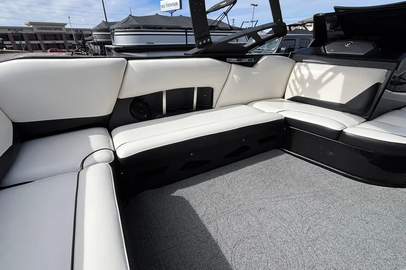Slide: The Image of 2012 Axis A22 boat interior with white and black seating, gray carpet, and modern design. - 10