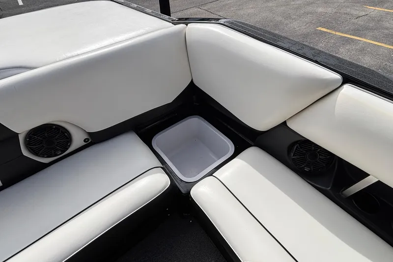 Slide: The Image of 2012 Axis A22 boat interior with white seating and built-in speakers. - 12
