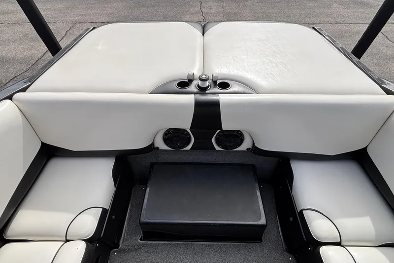 Slide: The Image of 2012 Axis A22 boat interior with white seating and cup holders. - 15