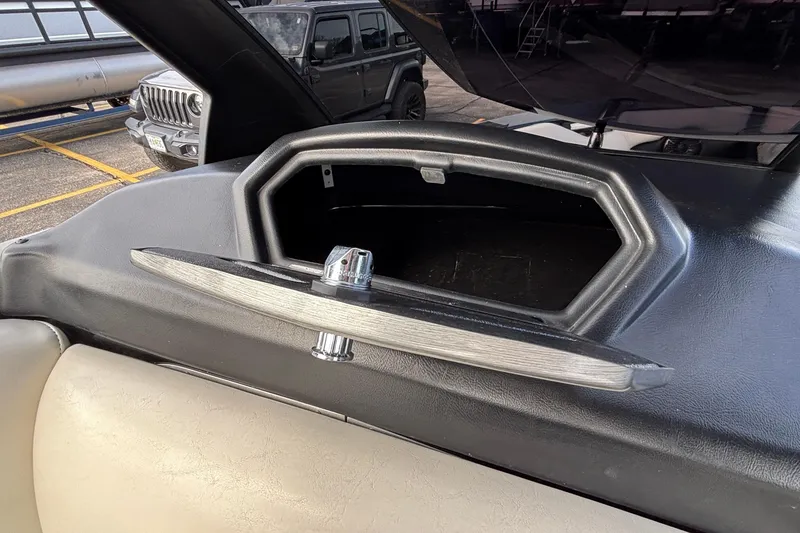 Slide: The Image of Open storage compartment in a 2012 Axis A22 boat dashboard. - 19