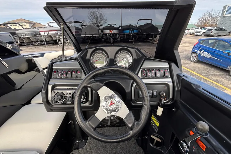 Slide: The Image of 2012 Axis A22 boat dashboard with steering wheel and control panel. - 20