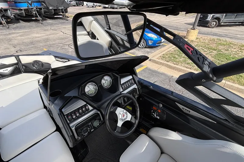 Slide: The Image of Interior view of a 2012 Axis A22 boat dashboard with steering wheel and controls. - 25