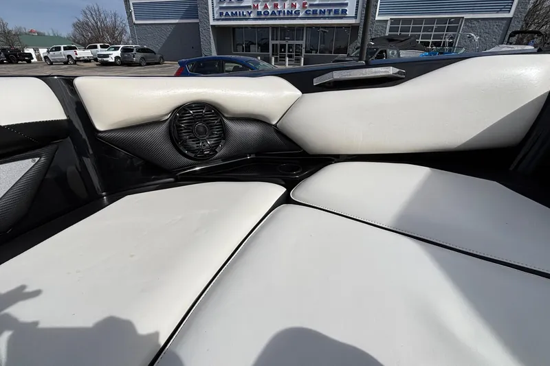 Slide: The Image of Interior of a 2012 Axis A22 boat with white seating and speaker detail. - 26