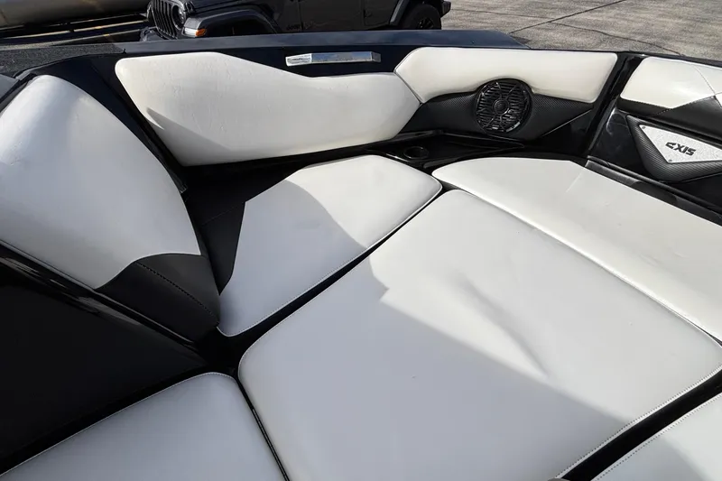 Slide: The Image of 2012 Axis A22 boat interior with white and black seating, featuring built-in speaker. - 27