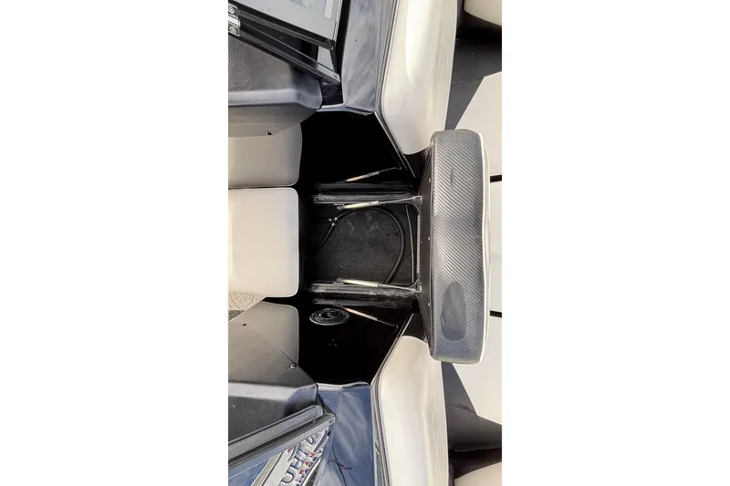 Slide: The Image of Interior view of a 2012 Axis A22 boat, featuring seating and storage area. - 29