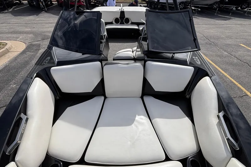 Slide: The Image of 2012 Axis A22 boat interior with white cushioned seating and black accents. - 30